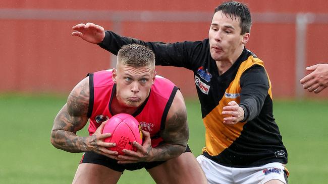 RDFL: Romsey’s Mitchell Caddy gathers in front of Scott Ilgoutz of Lancefield. Picture: George Sal