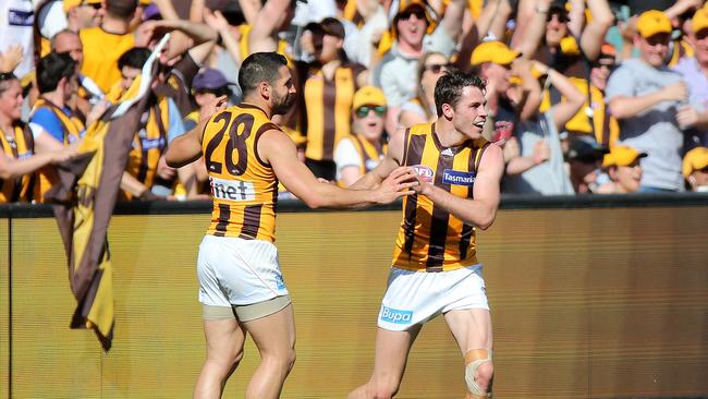 Puopolo (left) celebrates a goal with Isaac Smith during Hawthorn’s 2015 premiership win. Picture: Alex Coppel