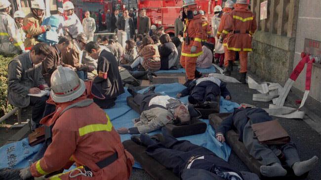 Subway passengers wait for medical attention outside Tokyo's Tsukiji Station after they collapsed as toxic fumes filled the metropolitan subway system. Picture: Supplied