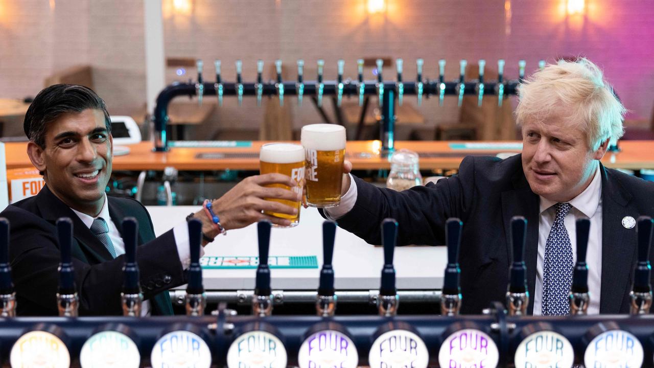 British Chancellor of the Exchequer Rishi Sunak (left) and Prime Minister Boris Johnson have reduced the tax on tap beer to encourage people to go back to pubs. Picture: AFP