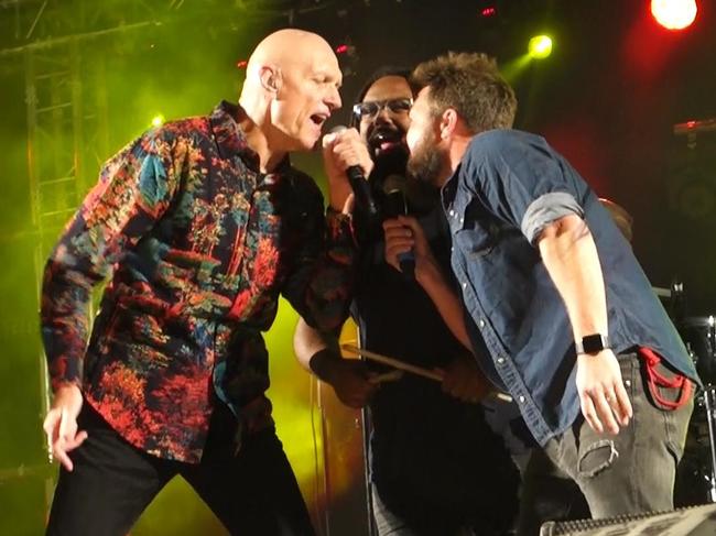 Jeremy Marou, middle, and Thomas Busby, right, sing Treaty with Peter Garrett in July. Picture: Dean Podlich