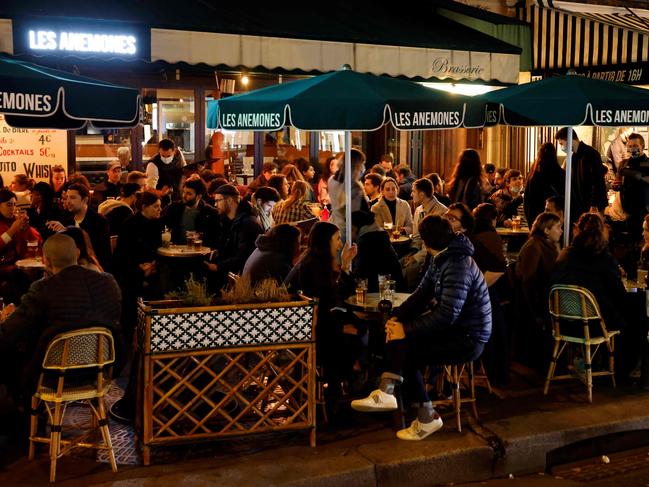 Parisians drink on a bar terrace in Paris, a few hours before the start of a national general lockdown. Picture: AFP)\