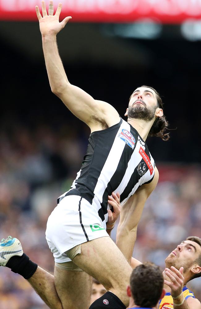 Brodie Grundy jumps over Scott Lycett. Picture: Michael Klein