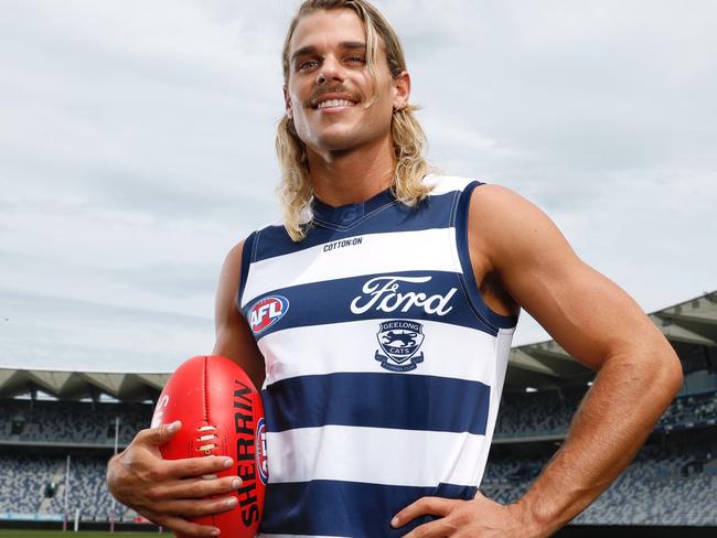 AFL star Bailey Smith proudly dons his new Geelong Cats jersey at GMHBA Stadium after being traded from the Western Bulldogs on Wednesday night. Picture: Michael Klein.