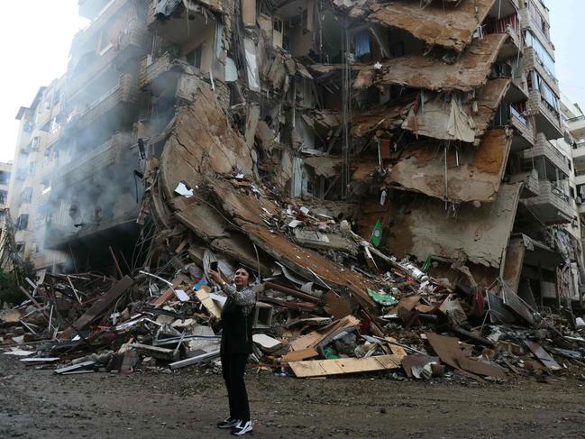 A woman takes a picture at the site of overnight Israeli airstrikes that targeted the Tayouneh suburb of Beirut on November 25, 2024. Picture: Ibrahim Amro / AFP