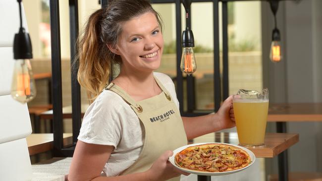 23/3/16. The Beach Hotel Seaford is featured in the Southern's Top 5 Meal Deals. They have Thursday's Tunes ( an Acoustic music night), where they have pizza's for $10 (usually $15) with cider jugs for $12 (usually $20). Staff member Wednesday White - 21yrs (Sellicks Beach) with a pizza and Cider jug Pic: Keryn Stevens