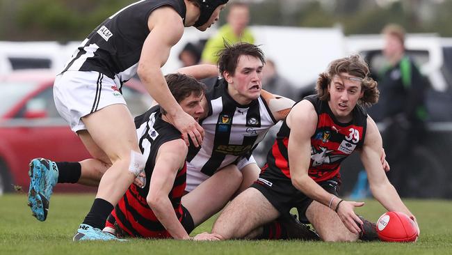 From left, Ryan Banks-Smith (Glenorchy), Josh McGuinness (Lauderdale), Aiden Grace (Glenorchy) and Liam Gallagher (Lauderdale) battle for possession. Picture: NIKKI DAVIS-JONES