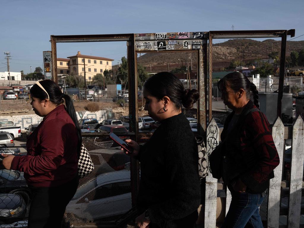 People walk as they queue on the pedestrian crossing to the United States at San Ysidro Crossing port in Tijuana, Baja California state, Mexico. Picture: AFP