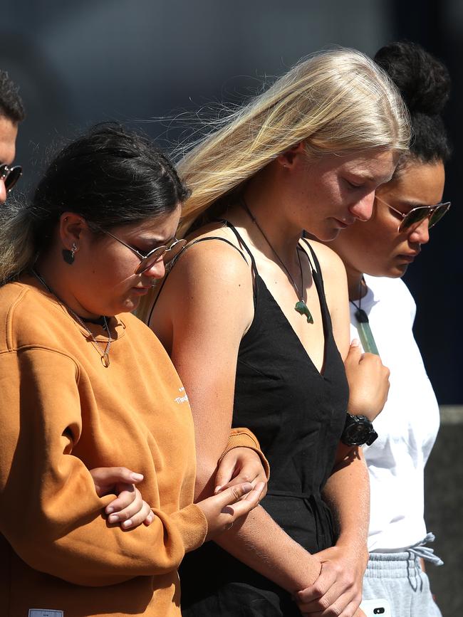 People are seen comforting each other outside the Te Manuka Tutahi Marae. Picture: Getty