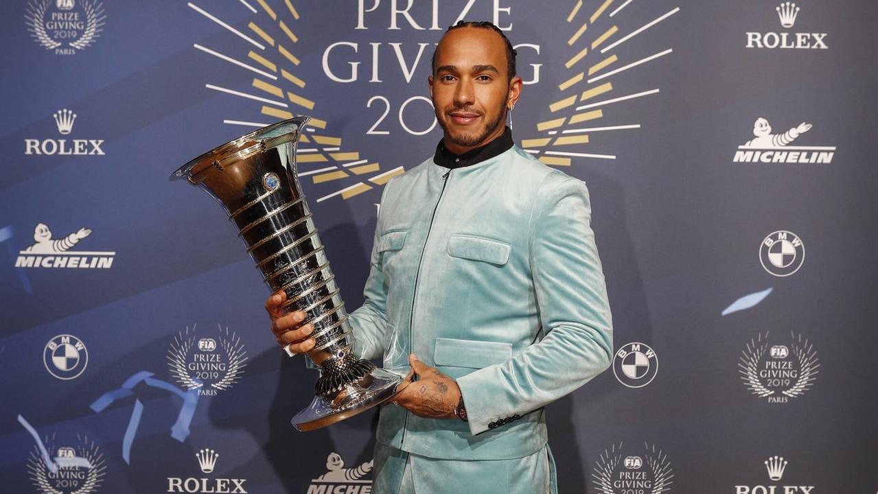 Hamilton poses with the drivers' title trophy. Picture: @MercedesAMGF1