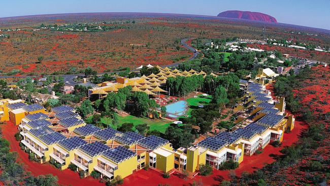 An aerial shot of Ayers Rock Resort with Uluru in the background. Picture; Voyages Tourism Australia