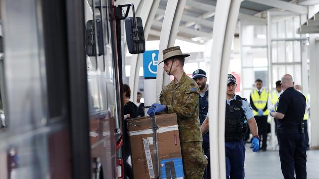 Passengers are placed on buses and ferried to hotels at Sydney International Airport over the weekend. Picture: Nikki Short