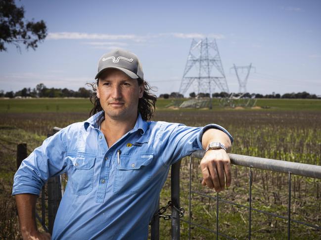 10/12/2024: Uranquinty. James Petersen and his neighbours are butting heads with Transgrid over the construction of transmission lines on their rural properties. Pictured: James with one of the towers currently being constructed on a neighbouring property.   PIC: Ash Smith