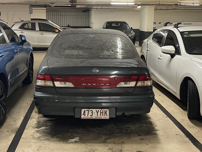 An abandoned Nissan Maxima 30G at the Uptown shopping complex car park. Photo: Supplied