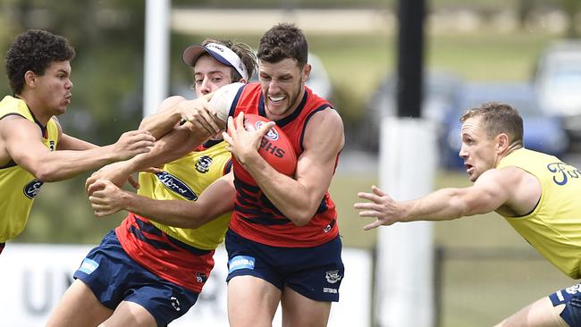 Sam Menegola bursts through a pack at Geelong training. Picture: Alan Barber