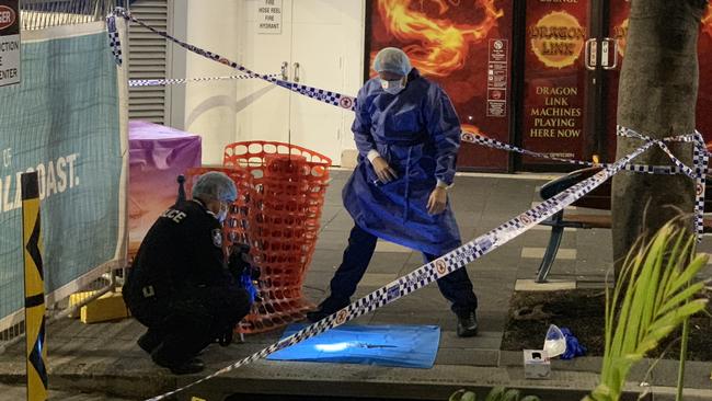 Police investigate the scene of the stabbing death of 27-year-old Raymond Harris in Surfers Paradise last year.