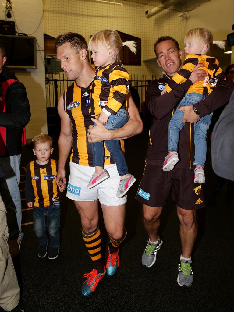 Sam Mitchell gets a hand from Alastair Clarkson with the kids after a match in 2014. Picture: Colleen Petch.