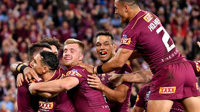Maroons players celebrate a try.