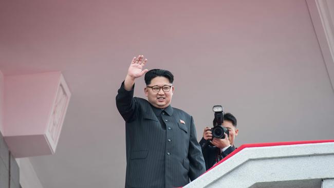 North Korean leader Kim Jong-un waving from a balcony of the Grand People's Study House to participants of a military parade and mass rally on Kim Il-Sung square in Pyongyang. (Pic: AFP)