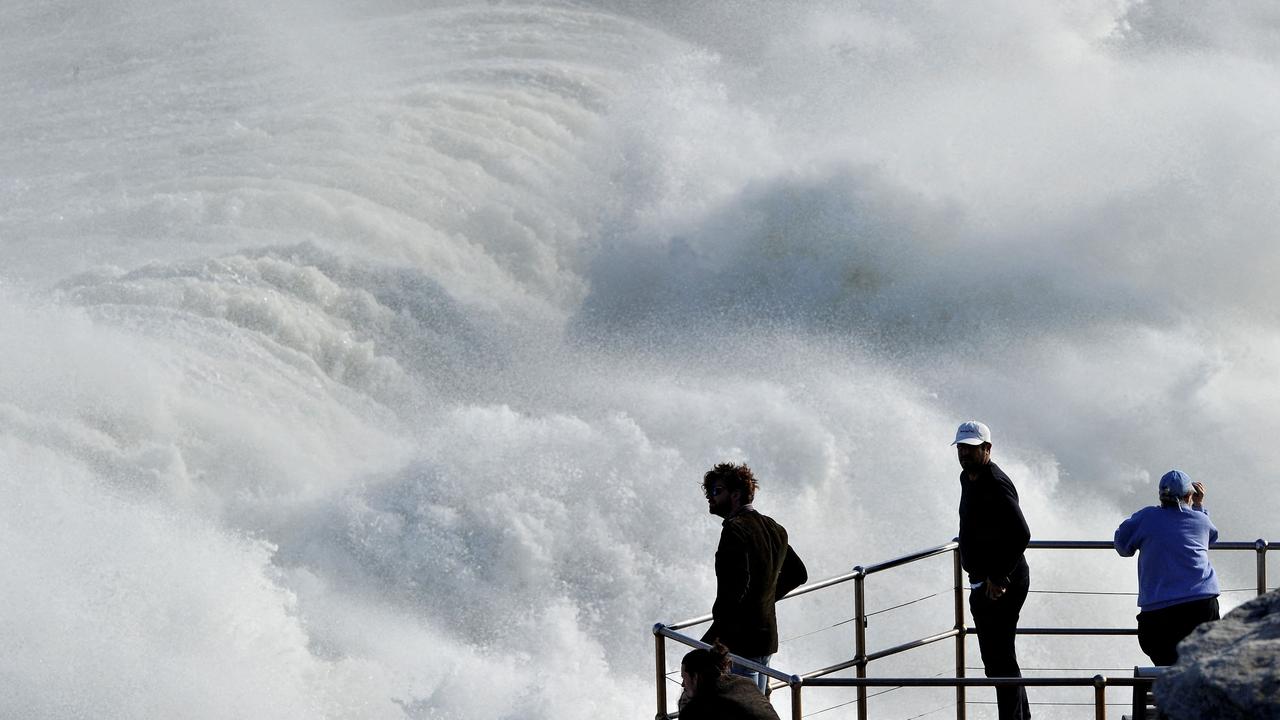 Residents watched huge waves crashing into rocks at Bondi Beach on Saturday. Picture: Muhammad Farooq/AFP