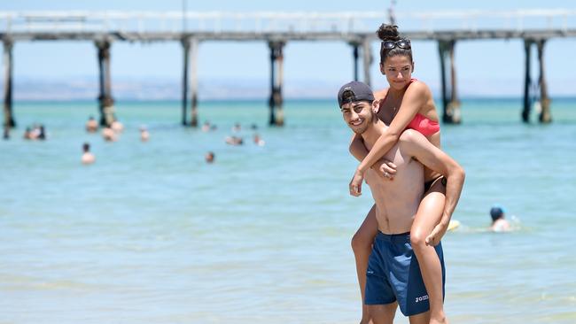 Sorina Cristea and John Samaras cool off at Henley Beach. Picture: Naomi Jellicoe