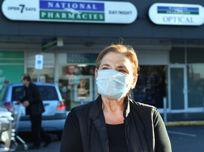 Yelta  out front of National Pharmacies at Findon Shopping Centre where a staff member tested positive to Covid-19., linked to the Adel Airport baggage handler outbreak.Yelta is worried about her sister who went to the Pharmacy on Saturday .Thursday 2 April,2020.(Image AAP/Mark Brake)