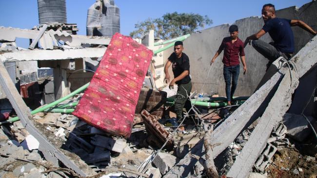 Palestinian emergency services and local citizens search for victims in buildings destroyed during Israeli air raids in the southern Gaza Strip on October 19, 2023. Picture: Ahmad Hasaballah/Getty Images