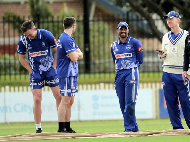 Players wait as rain halts play during round 1 NSW Premier Grade cricket match between Bankstown and UNSW at Bankstown Oval on September 24, 2022 in Bankstown, Sydney, Australia. (Photo by Jeremy Ng/Newscorp Australia)