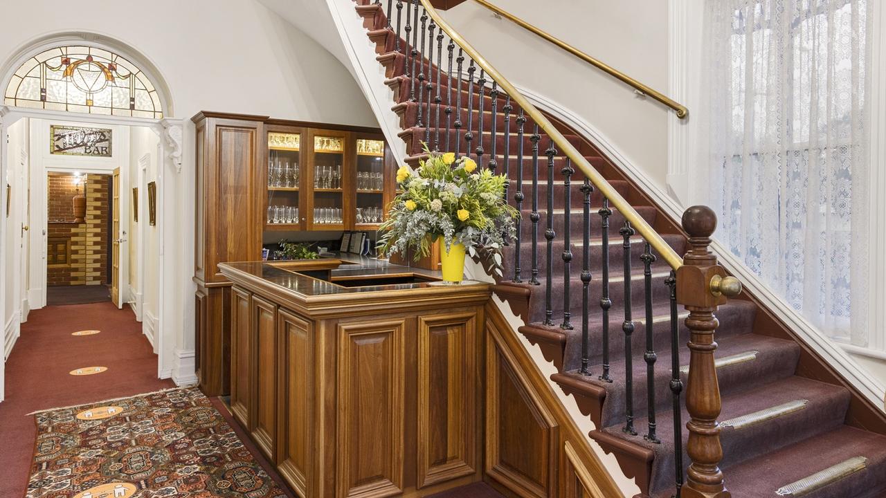 The grand staircase features original bronze balustrades and treads.