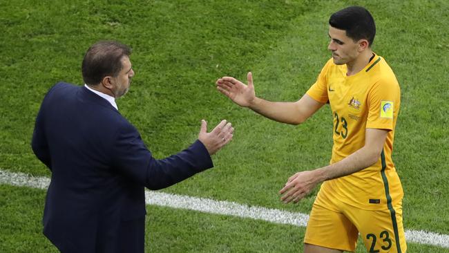 Australia's Tomas Rogic shakes hand with Australia coach Ange Postecoglou, left, as he is substituted during the Confederations Cup, Group B soccer match between Australia and Germany.