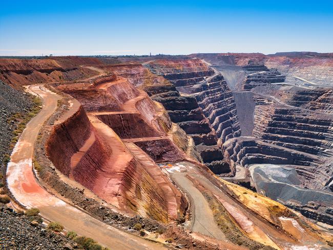 The giant Super Pit or Fimiston Open Pit, the largest open pit gold mine of Australia, in Kalgoorlie, Western Australia. Huge terraces of red and black stone, dirt roads leading to the bottom.Escape 9 February 2025Take A TourPhoto - iStock