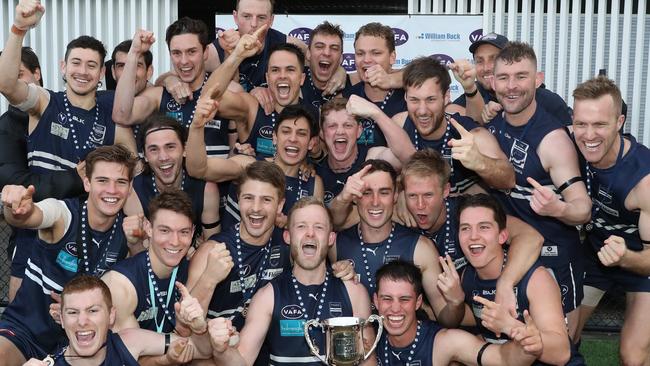 The jubilant Caulfield Grammarians team with the premiership cup.