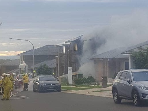 Smoke rises from the home on Saturday evening. Picture: Kellyville Rural Fire Brigade