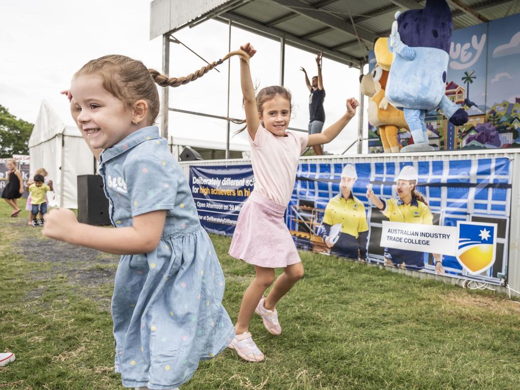 (from left) Bella McGrath and Phoebe Evans dance during the Bluey show at the Toowoomba Royal Show. Saturday, March 26, 2022. Picture: Nev Madsen.