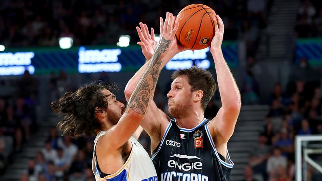 MELBOURNE, AUSTRALIA - DECEMBER 08: Robert Loe of United looks to pass the ball under pressure from Tyrell Harrison of the Bullets during the round 11 NBL match between Melbourne United and Brisbane Bullets at John Cain Arena, on December 08, 2024, in Melbourne, Australia. (Photo by Josh Chadwick/Getty Images)