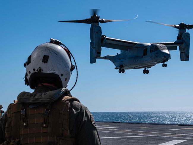 This handout photo taken on July 8, 2023 and released on July 26, 2023 by the US Marine Corps shows Capt. Andrew Johnson, an MV-22B Osprey tiltrotor aircraft pilot with Marine Medium Tiltrotor Squadron 363 (Reinforced), Marine Rotational Force - Darwin 23, watching an MV-22B Osprey land on Royal Australian Navy ship HMAS Adelaide (L01) during Exercise Southern Jackaroo 23, off the coast of Queensland, Australia. US military officials on August 28, 2023 named three marines killed in an aircraft crash in northern Australia, as investigators try to unearth clues about the cause of the incident. Corporal Spencer Collart, 21, Captain Eleanor LeBeau, 29, and Major Tobin Lewis, 37, were among 23 marines on board the Boeing MV-22B Osprey when it crashed on Melville Island, north of Darwin on the morning of August 27 during a military exercise for locally based troops. (Photo by Skyler M. HARRIS / US MARINE CORPS / AFP) / RESTRICTED TO EDITORIAL USE - MANDATORY CREDIT "AFP PHOTO / US MARINE CORPS /  Cpl. Skyler M. Harris" - NO MARKETING - NO ADVERTISING CAMPAIGNS - DISTRIBUTED AS A SERVICE TO CLIENTS