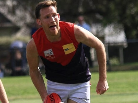 Sam Rickard looks to give off a handball. Picture: Davis Harrigan