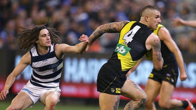 Dustin Martin brushes off a tackling attempt from Geelong’s Gryan Miers in Round 12. Picture: Michael Klein.