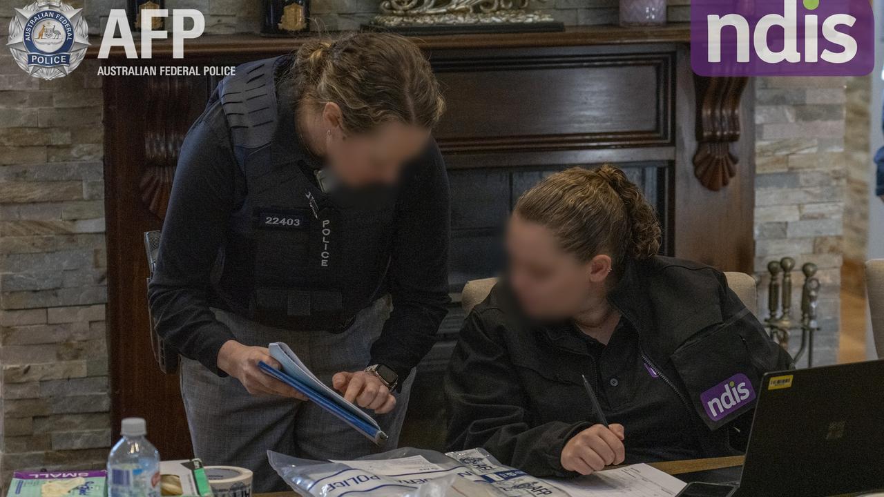 Investigators go through documents during a raid in western Sydney. NDIS Minister Bill Shorten says the tempo for raids, investigations and prosecutions is rising. Picture: AFP/NDIS