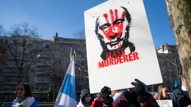 An anti Putin placard seen hold by a demonstrator during a protest outside the Russian Embassy to the European Union. Picture: Getty