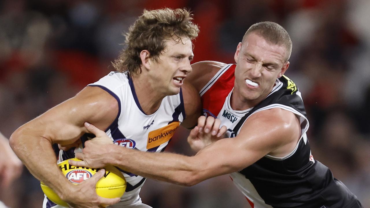 MELBOURNE, AUSTRALIA - MARCH 19: Callum Wilkie of the Saints tackles Nat Fyfe of the Dockers during the round one AFL match between St Kilda Saints and Fremantle Dockers at Marvel Stadium, on March 19, 2023, in Melbourne, Australia. (Photo by Darrian Traynor/Getty Images)