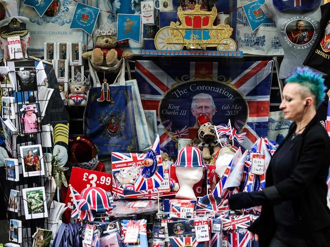 A pedestrian walks past a merchandise shop selling royals souvenirs, in Windsor, on May 2, 2023, ahead of the coronation ceremony of Charles III and his wife, Camilla, as King and Queen of the United Kingdom and Commonwealth Realm nations, on May 6, 2023. (Photo by Adrian DENNIS / AFP)