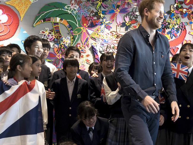 Britain's Prince Harry leaves a photo session with students as he visits the Nippon Foundation Para Arena in Tokyo. Picture: AP