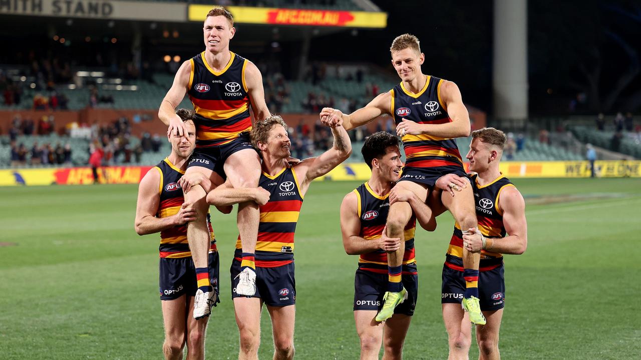 Tom Lynch and David Mackay of the Crows are chaired off after their last game.