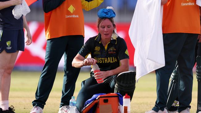 SHARJAH, UNITED ARAB EMIRATES - OCTOBER 05: Beth Mooney of Australia cools down with an ice pack in a drinks break, during the ICC Women's T20 World Cup 2024 match 5 between Australia and Sri Lanka at Sharjah Cricket Stadium on October 05, 2024 in Sharjah, United Arab Emirates. (Photo by Matthew Lewis-ICC/ICC via Getty Images)