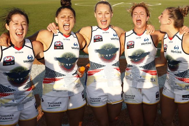 Crows players sing the team song after beating Melbourne at Casey Fields in Melbourne.