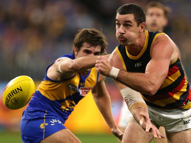 PERTH, AUSTRALIA - AUGUST 11: Taylor Walker of the Crows handball during the round 21 AFL match between the West Coast Eagles and the Adelaide Crows at Optus Stadium on August 11, 2019 in Perth, Australia. (Photo by Paul Kane/Getty Images)