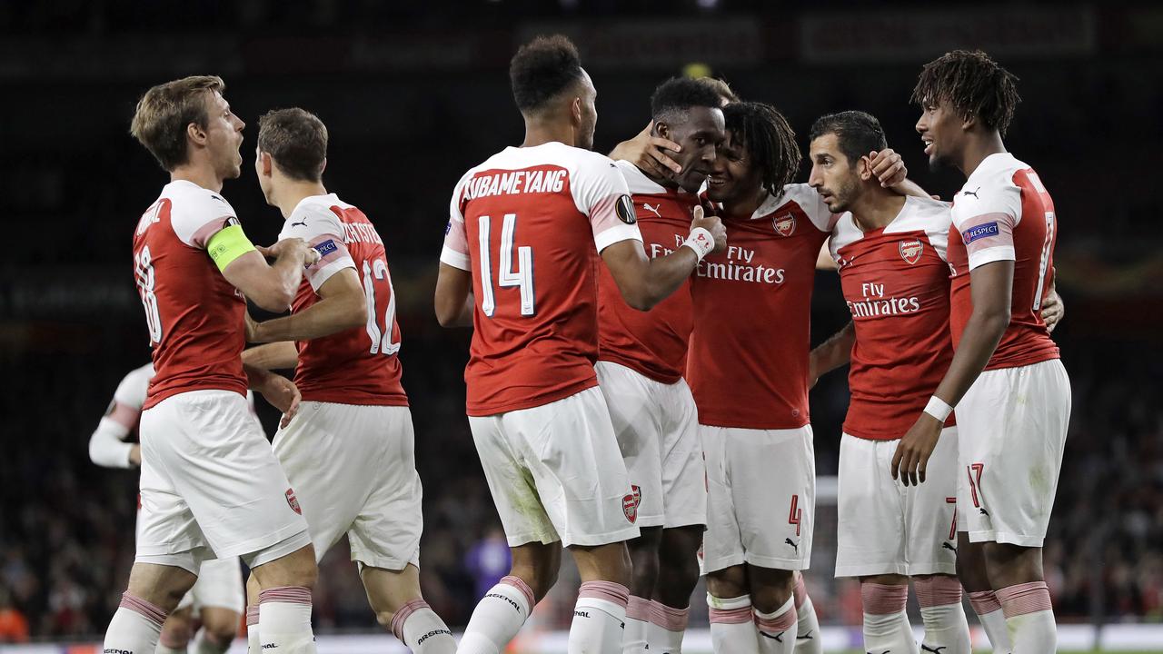 Arsenal's Danny Welbeck, center, is celebrated after scoring his side's second goal