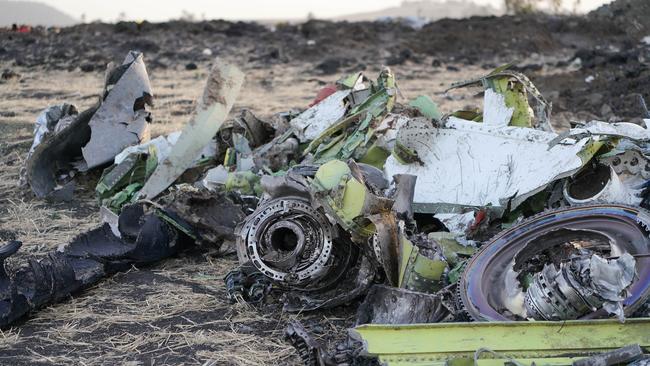 Parts of an engine and landing gear lay in a pile after being gathered by workers during the continuing recovery efforts at the crash site of Ethiopian Airlines flight ET302. Picture: Getty Images