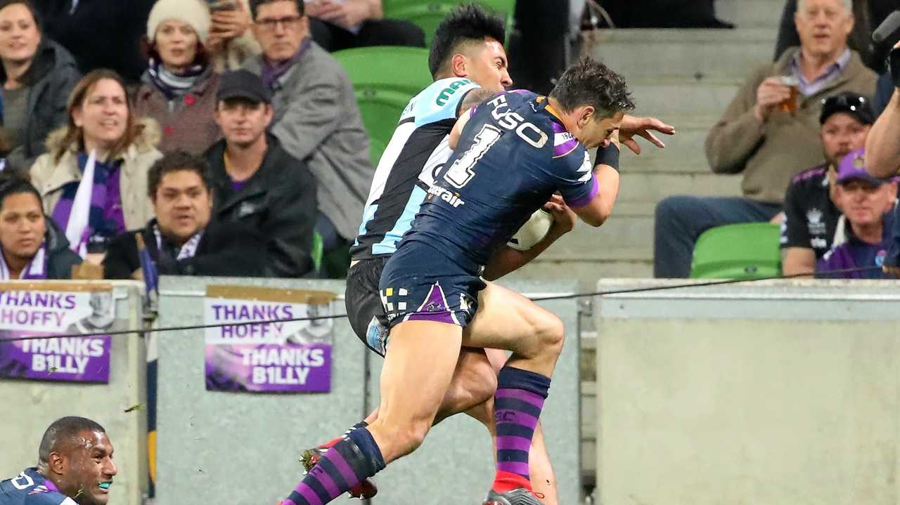 Billy Slater does a shoulder charge on Sosaia Feki of the Sharks to stop him from scoring a try  during the NRL Preliminary Final match between the Melbourne Storm and the Cronulla Sharks.  (Photo by Scott Barbour/Getty Images). Picture: Scott Barbour